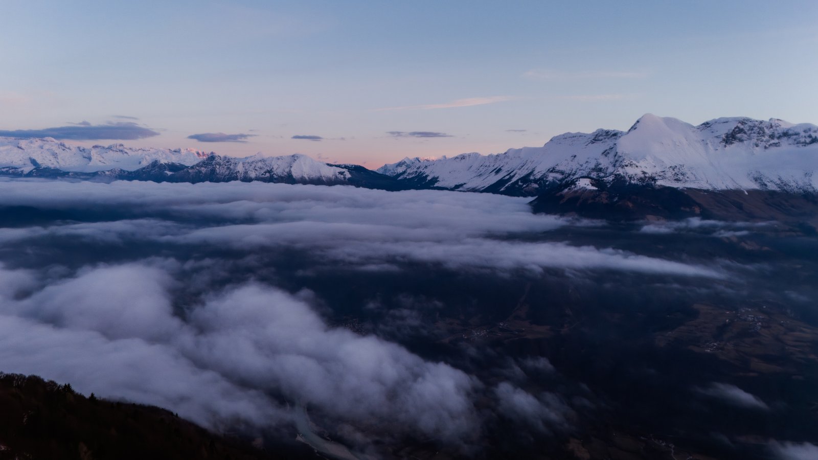 Vast sky above a sea of clouds and snowy mountain peaks, the openness of real freedom