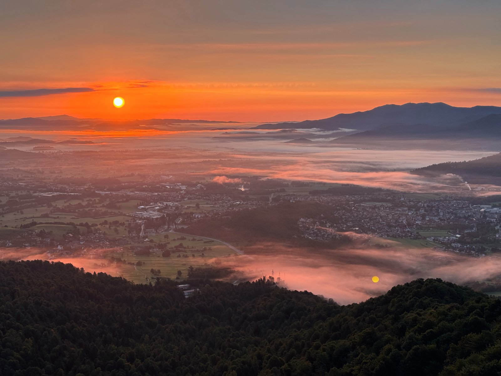 Sunrise over the valley as seen from the hilltop during the original challenge, fog rolling through the towns below